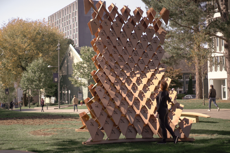 A woman looks at an architectural art installation