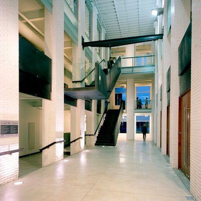 Inner view of the Architecutre building with stairs and students walking around