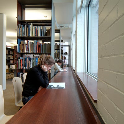 Two students are reading in the library