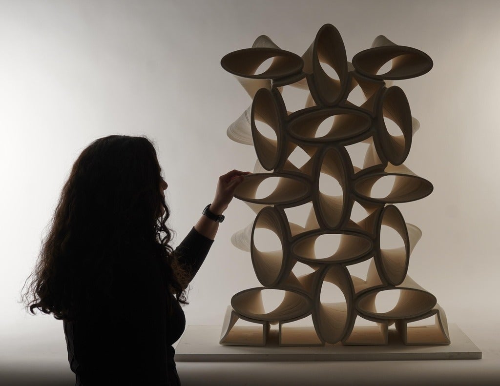 silhouette of a woman looking at a 3d printed sculpture