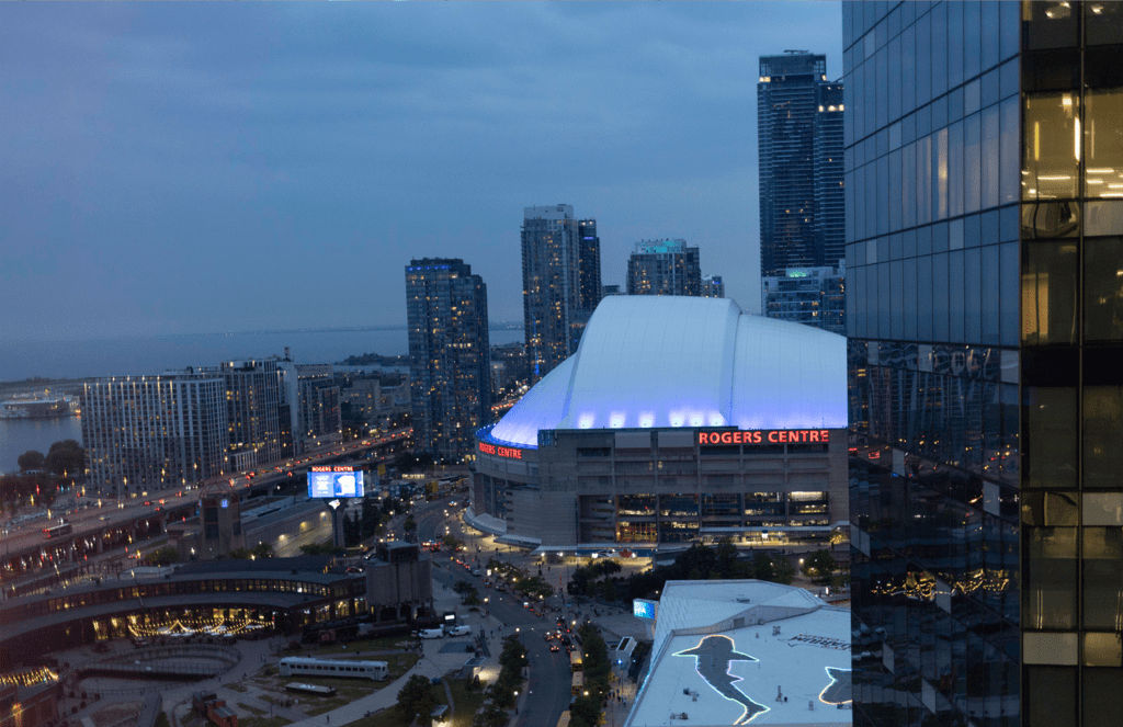 aerial view of the toronto waterfront and roger's centre at dusk