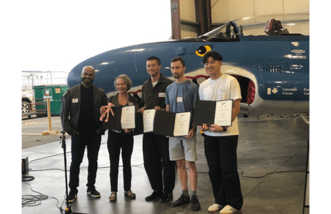 Three students accepting their CSC design award