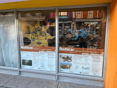 a store window displaying a student work exhibition poster