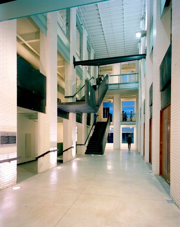 Inner view of the Architecutre building with stairs and students walking around