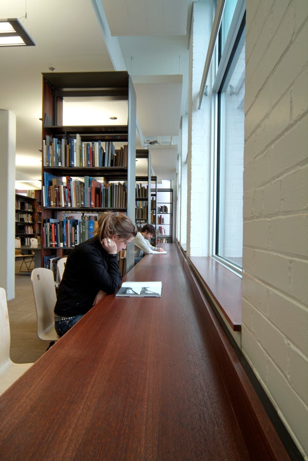 Two students are reading in the library
