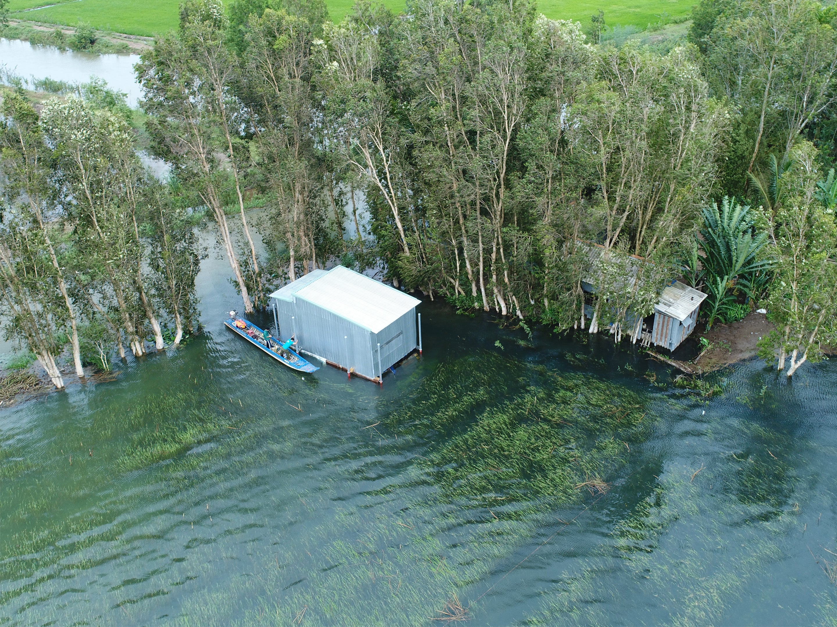 house of a rice farmer floating during the 2018 monsoon flood