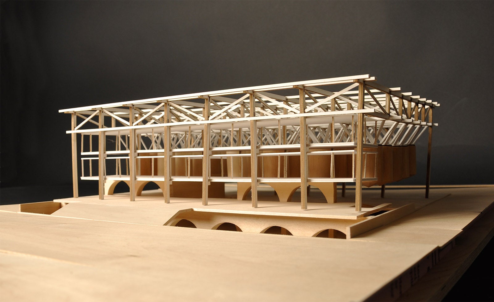 A detailed wooden model of a container storage facility from the exterior. Truses and support systesms are visible.