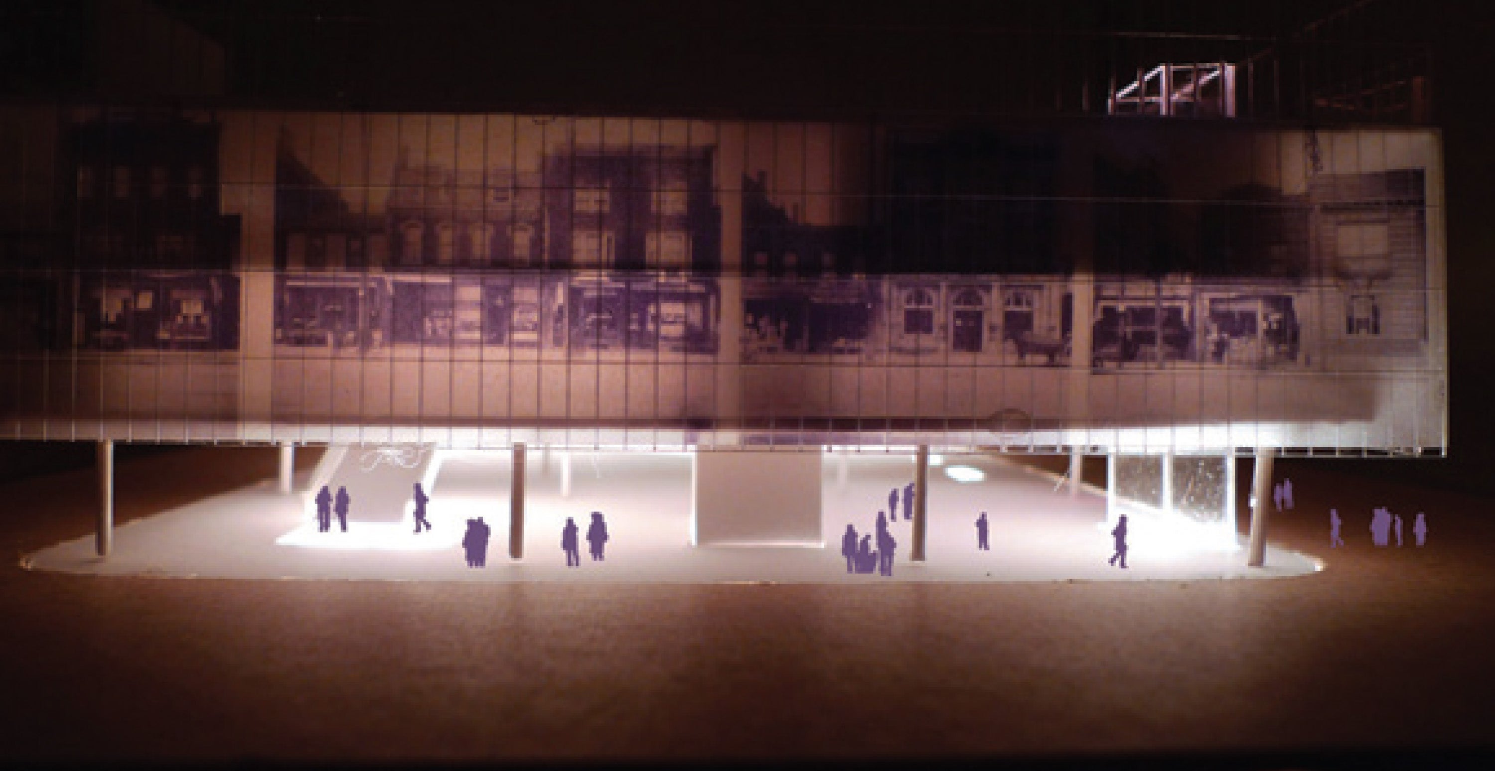 A physical model of a large urban building, it is lit with LED lights from the interior.
