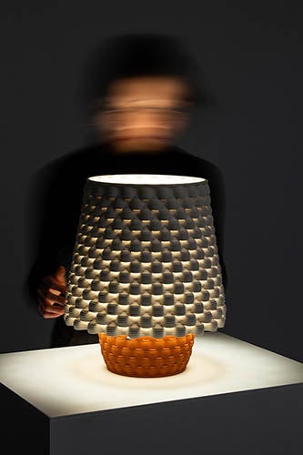 ceramic light fixture with motion blurred person in background