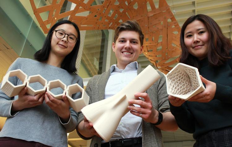 Graduate students Joanne Yau (left to right), Victor Tulceanu and Yesul (Elly) Cho show off the bricks they made out of clay using a new 3D printer at the University of Waterloo School of Architecture.