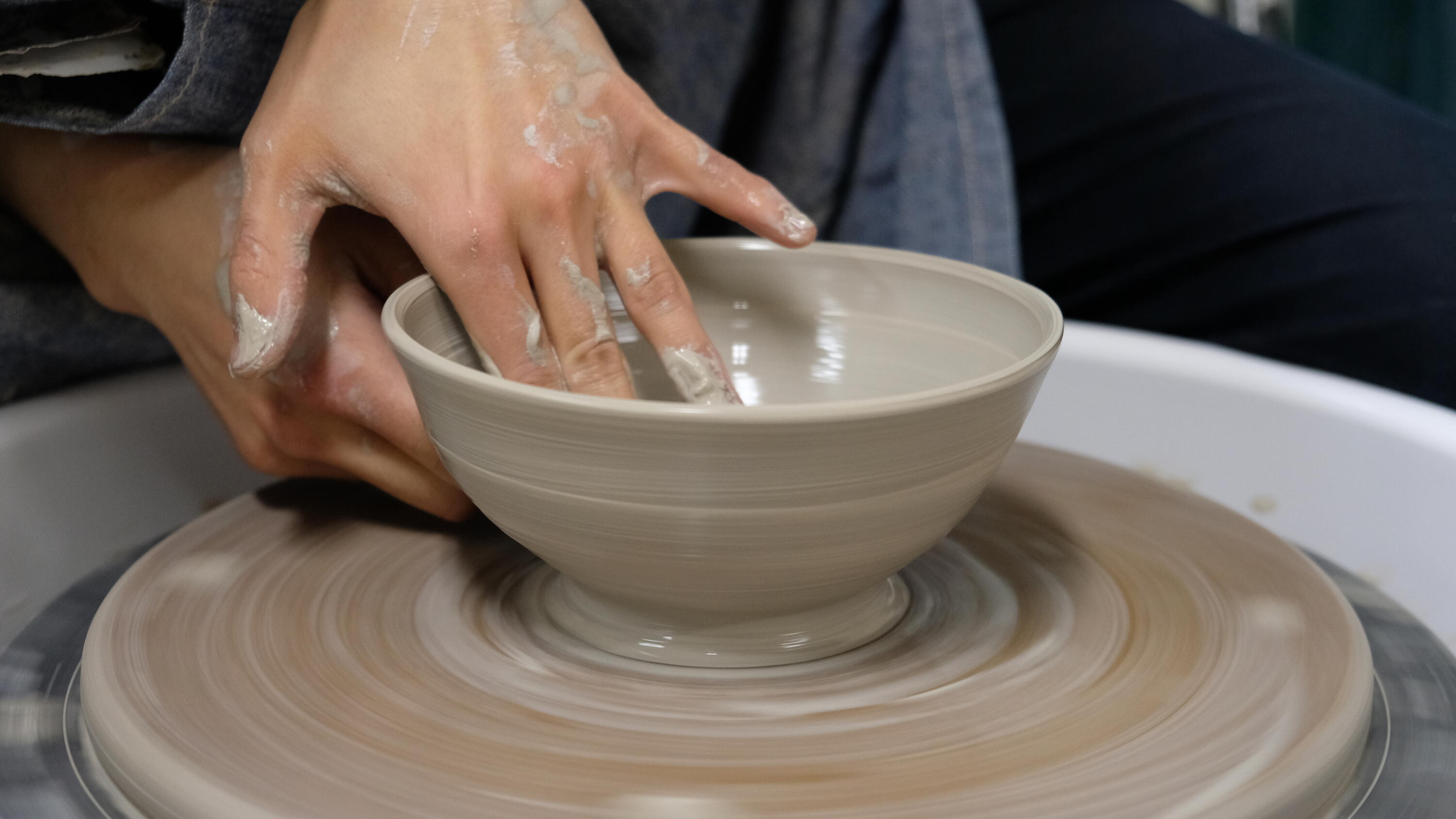 image of hands creating pottery