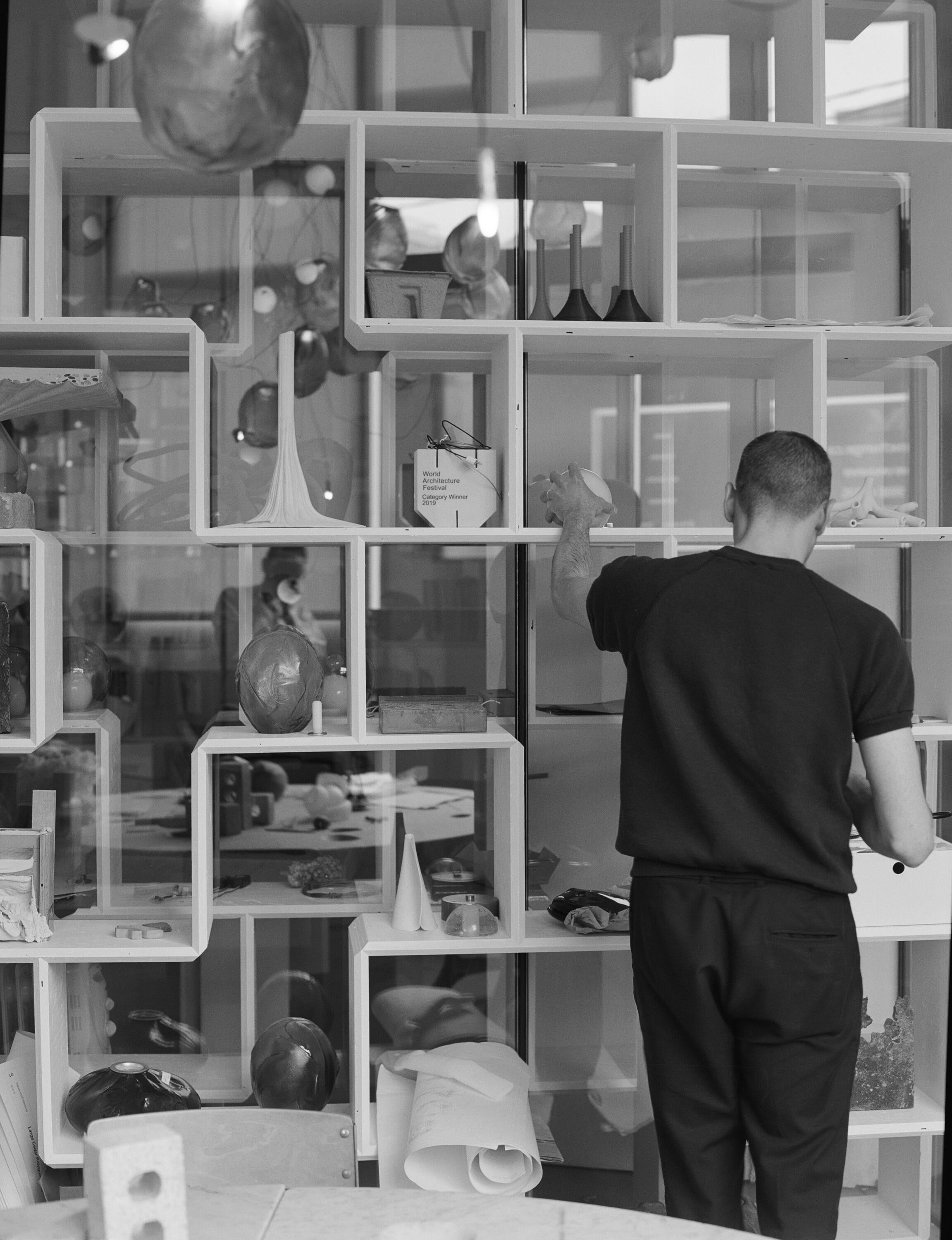 Omer Arbel Standing at his display shelves
