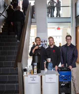 Students at Open House Offering Coffee and Q&A