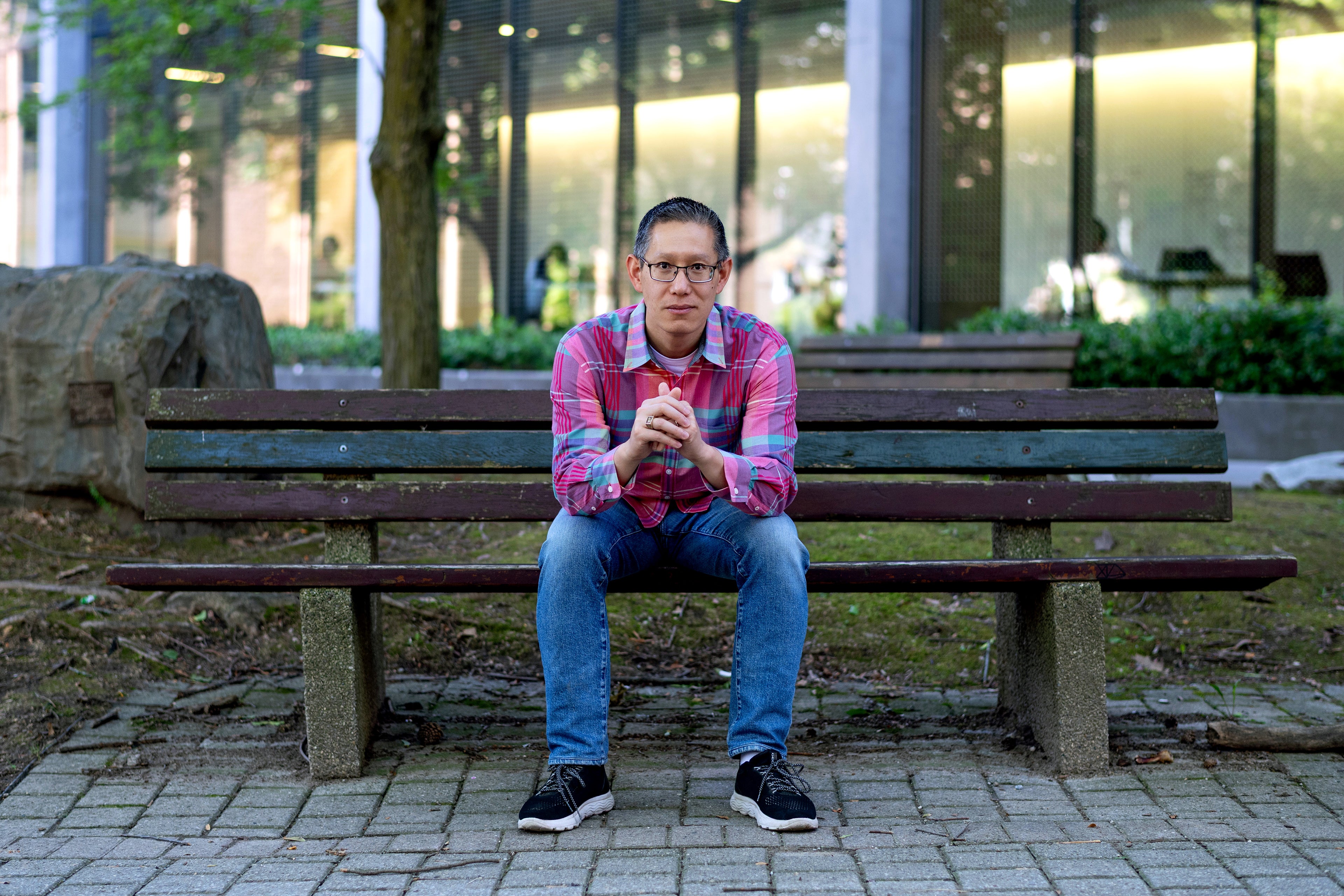 Professor Jimmy Lin sitting on a bench in Waterloo's Rock Garden