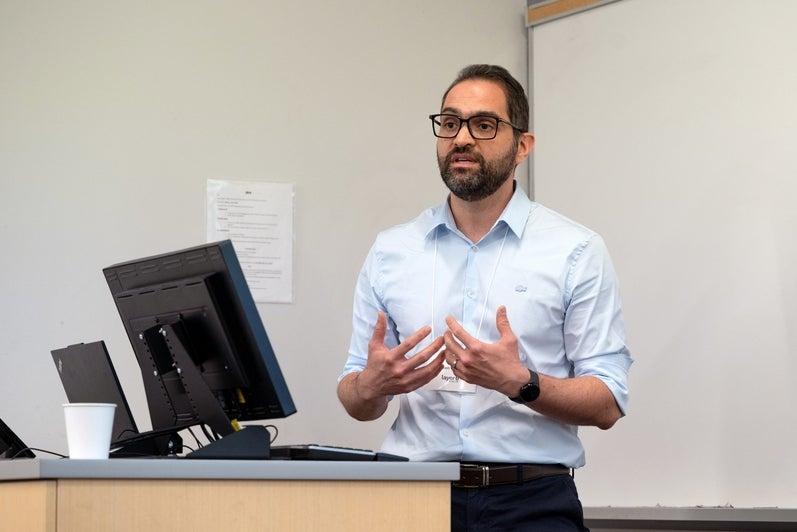 A speaker gestures while presenting during the TD Layer 6 visit