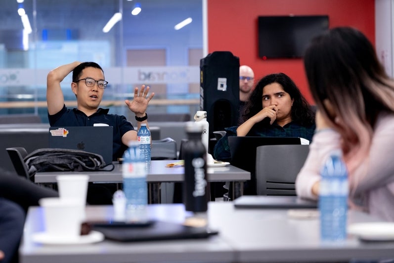 An attendee asks a question during a discussion at the TD Layer 6 visit