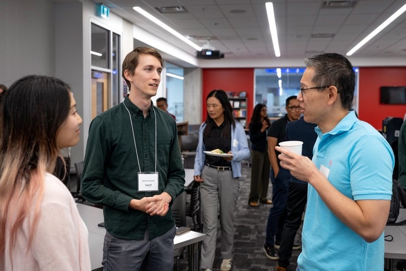 Attendees mingle and talk during the networking session