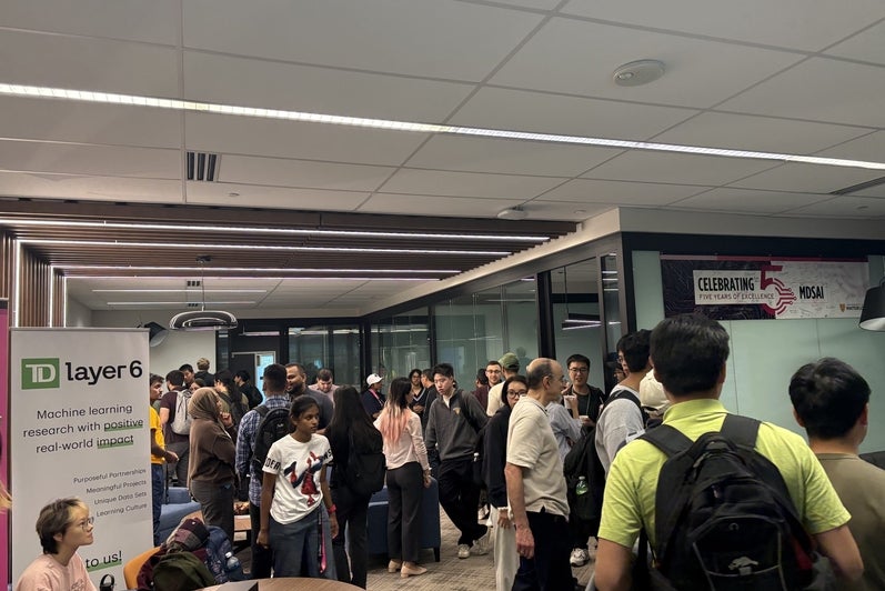 Students fill the room during the coffee hour with the TD Layer 6 team