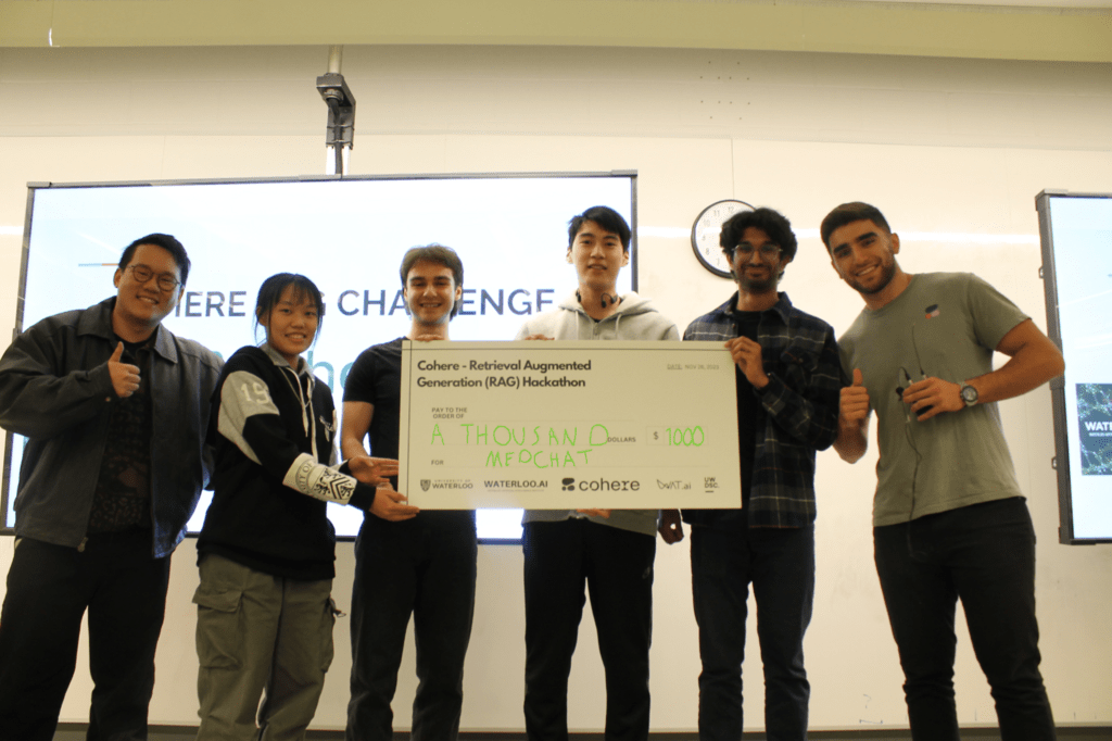 The MedChat Team pose in front of a cheque for $1000