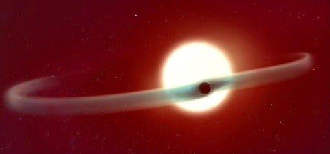 An illustrated space scene shows a bright star with a surrounding disk of material and an orbiting planet, representing an astronomical or astrophysics concept.