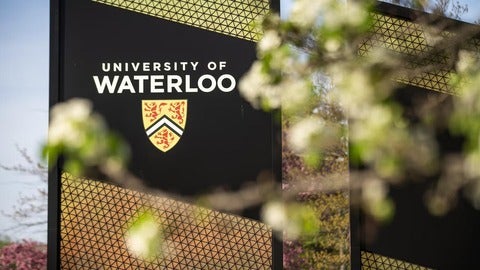 University of Waterloo sign with spring blossoms