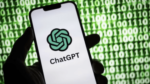  The image displays a hand holding a smartphone with the ChatGPT logo on the screen, set against a backdrop of green binary code.