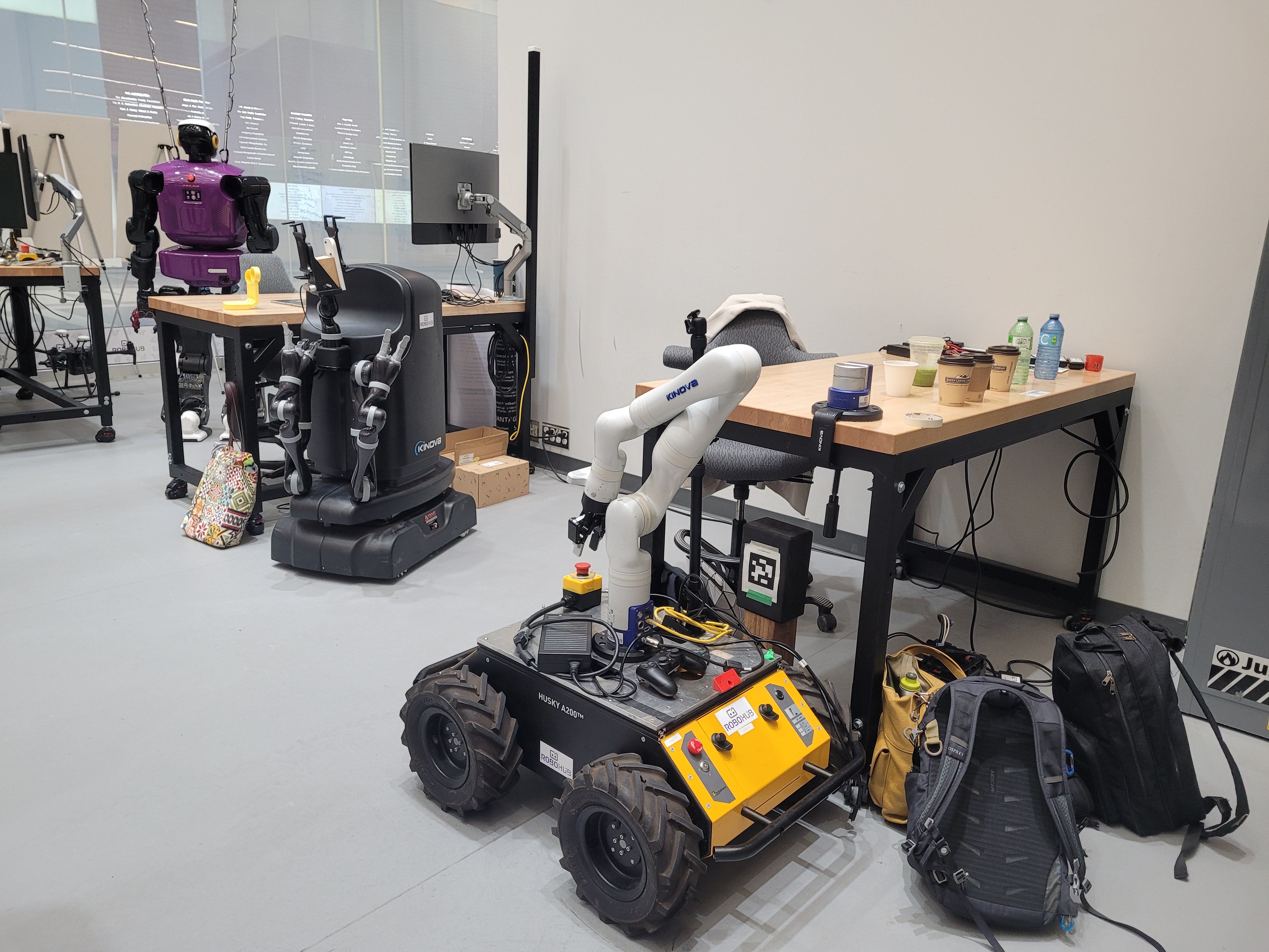 The TALOS humanoid robot and a Husky rover on display at RoboHub.