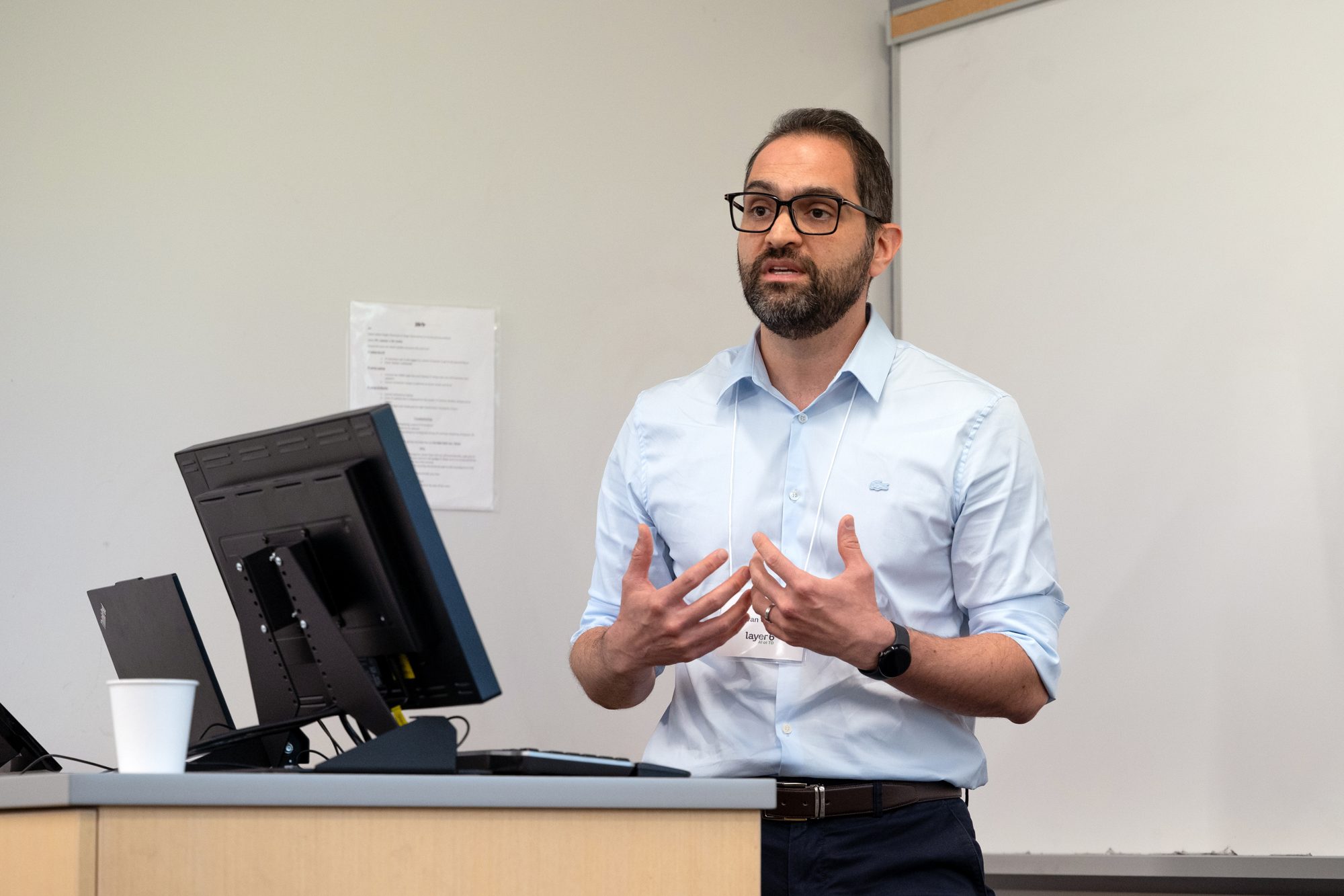 A speaker gestures while presenting during the TD Layer 6 visit