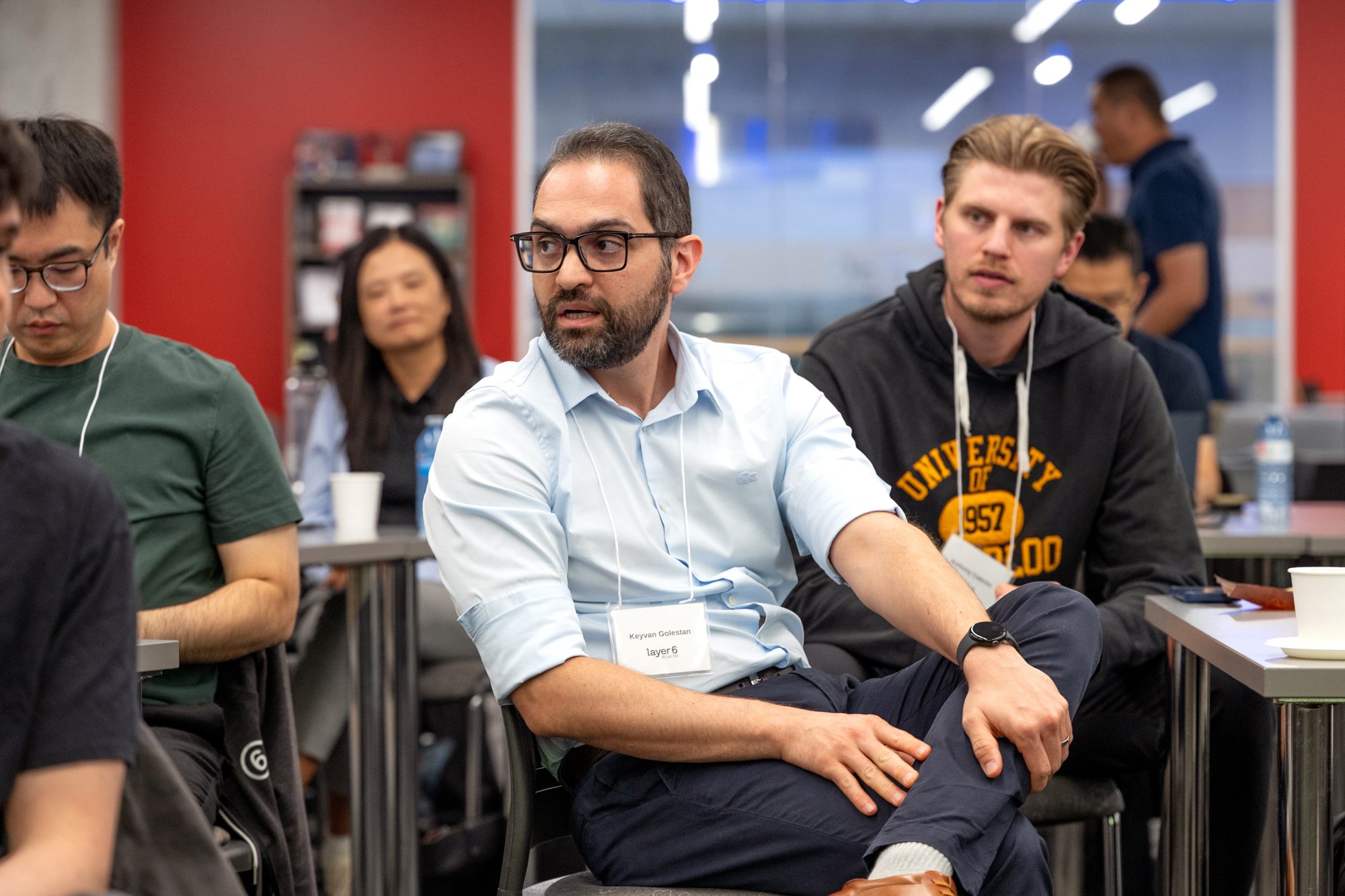 Attendees listen and react during a presentation