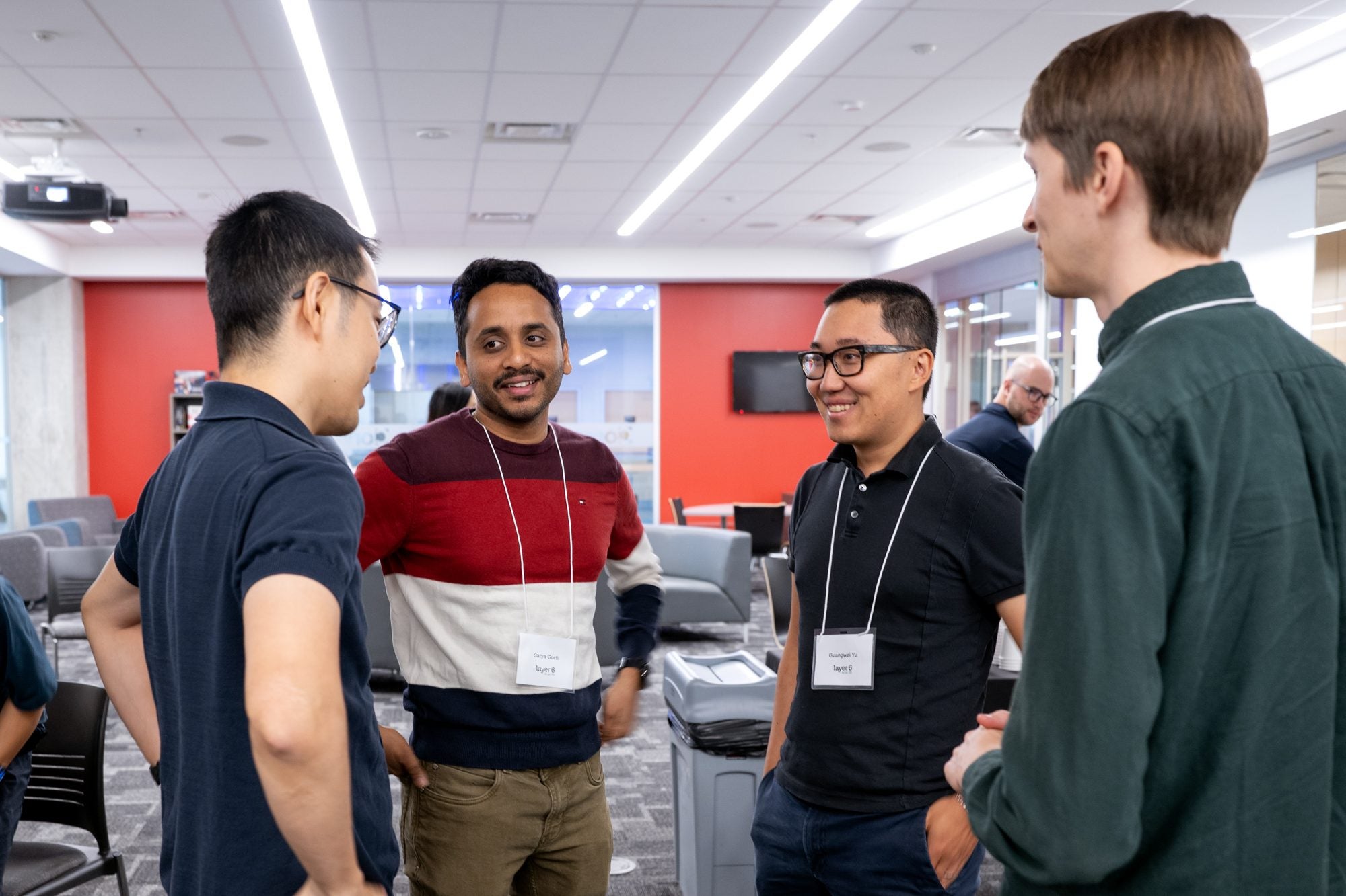 A group of attendees chat and network after the presentations