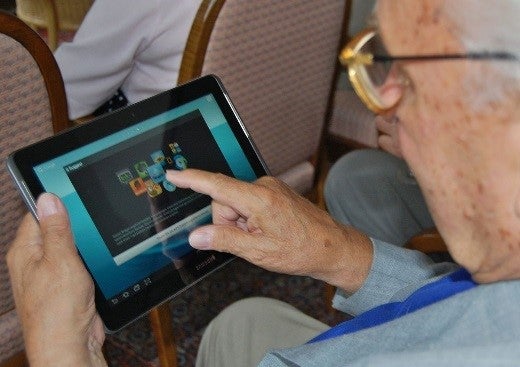 Elderly man using computer tablet