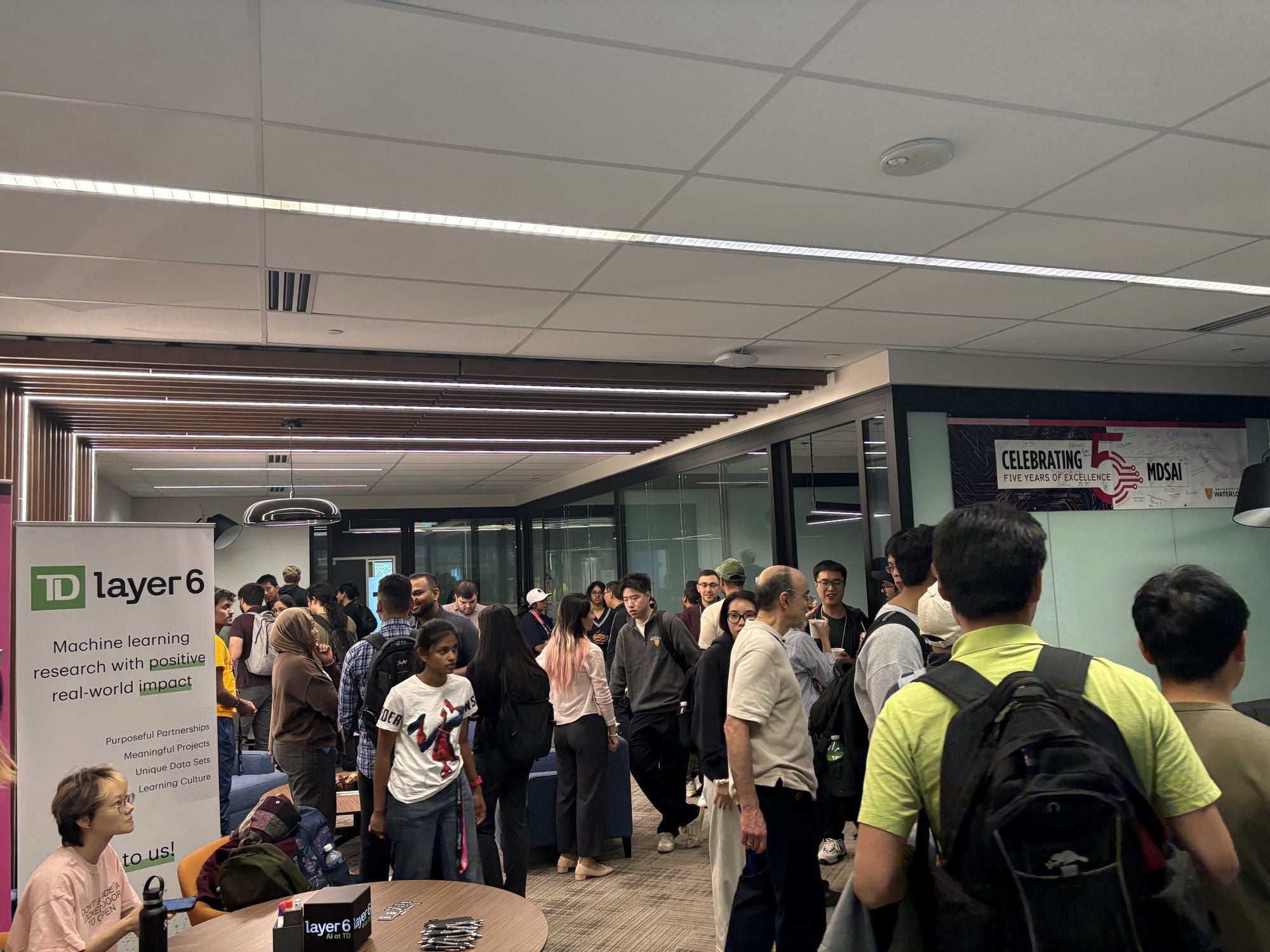 Students fill the room during the coffee hour with the TD Layer 6 team