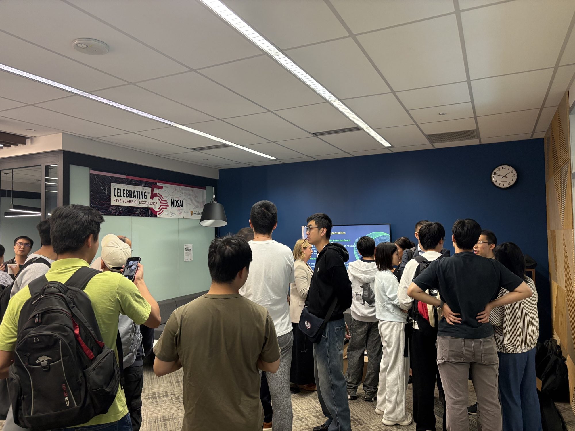 Students line up to talk with TD Layer 6 researchers during the coffee hour
