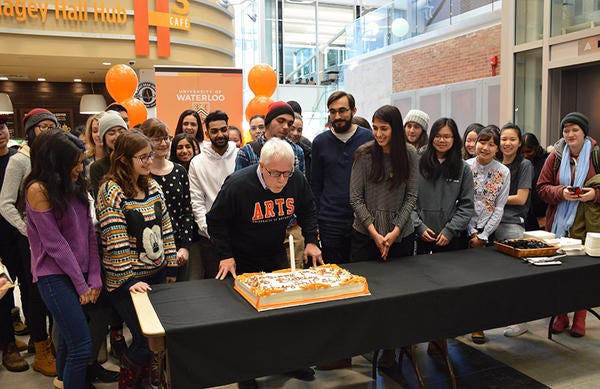 Dean Douglas Peers blows out a candle on the Hub birthday cake
