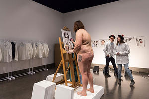 Tess Marten painting in the nude as part of one of her performances