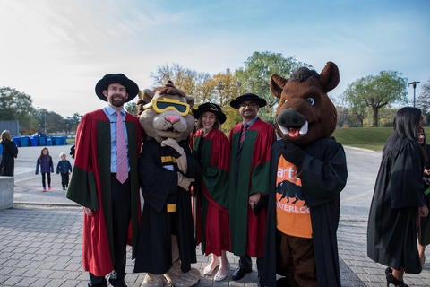 PhD grads and mascots at convocation