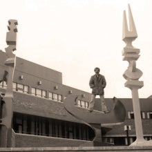 vintage photot of man standing on sculpture