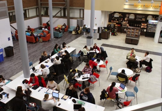 students working at counters and tables in the Hub mainfloor