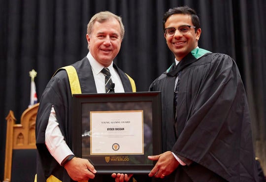Hyder Hassan and Tom Jenkins with framed award at convocation
