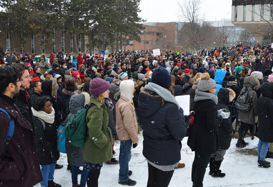 crowd gathered in wintertime on campus