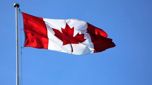A Canadian flag blows in the breeze