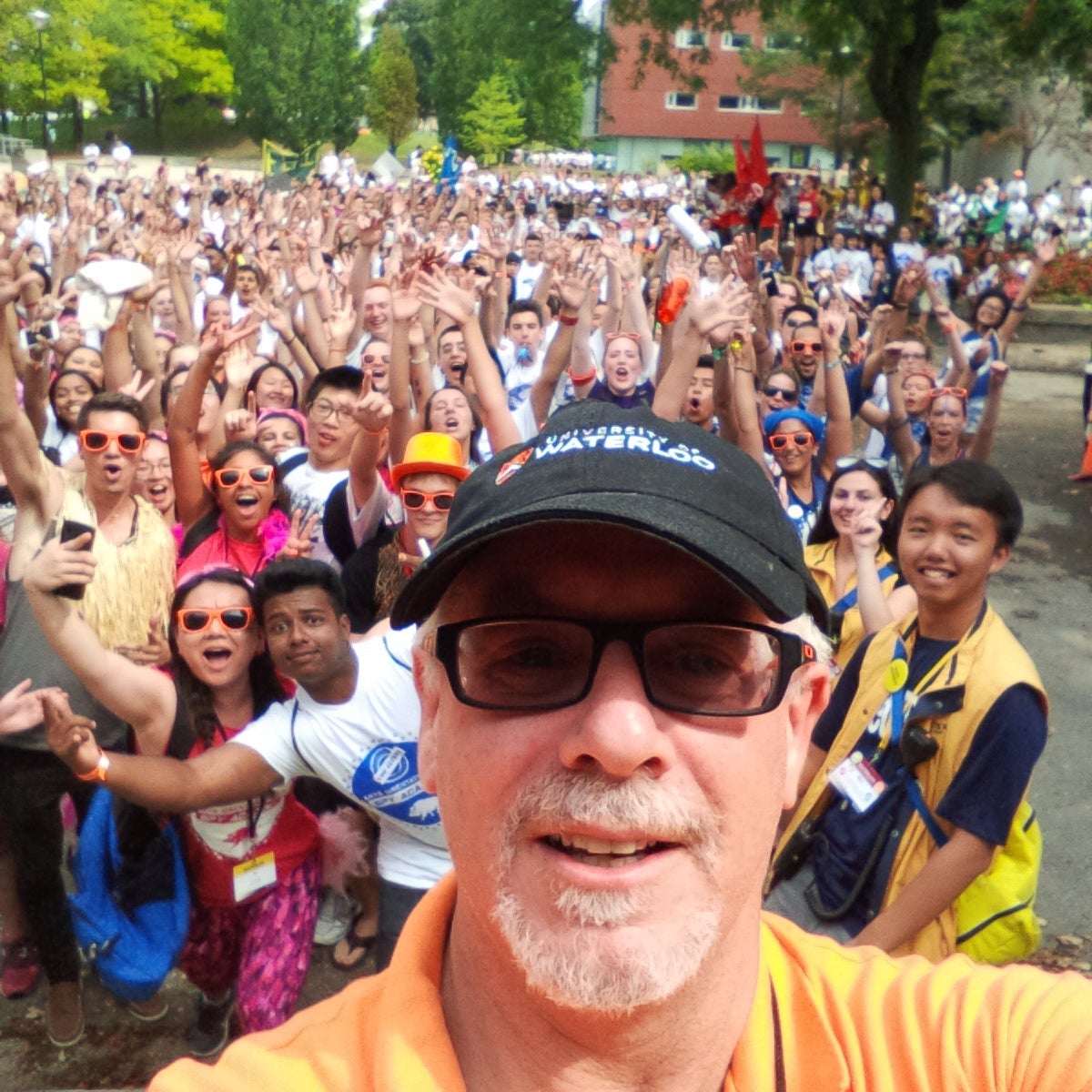 Doug Peers selfie with large group of students in background