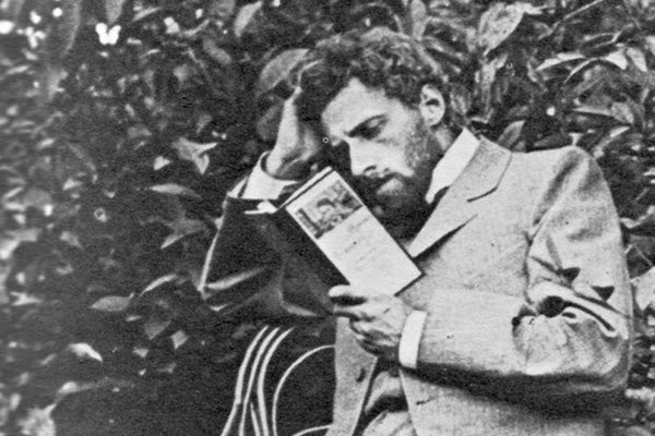 Archival photo of Meyerhold reading the Seagull and looking confused or distraught