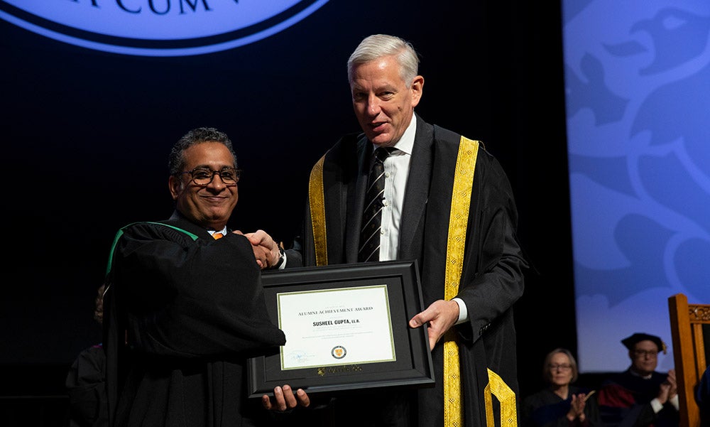Susheel Gupta receiving his award from chancellor Dominic Barton