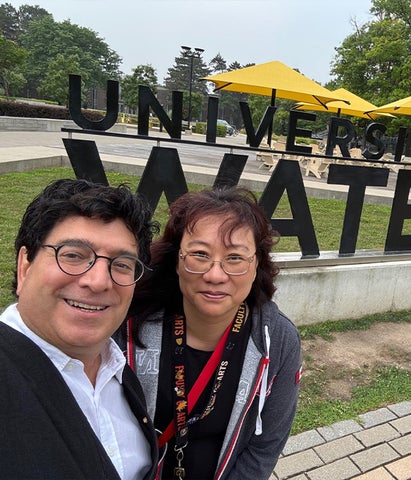 Mark Ceolin with Phoebe Wong in front of the UWaterloo sign
