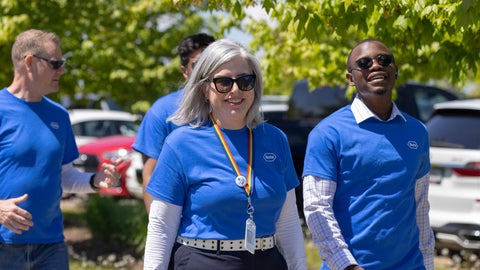 Brigitte Nolet and coworkers at a company event, wearing their Roche branded shirts