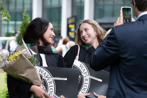 Two friends celebrating together at convocation