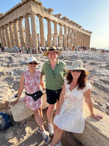 Selene Hur, Aimee Hawkins and Gosia Brestovaki pose near the Parthenon in Greece