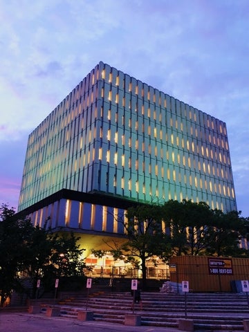 The Dana Porter Library lit up with bright colours on a summer's night