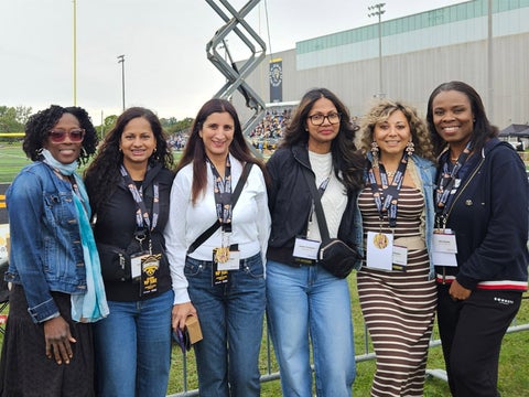 Six women gathered at Warrior Field for homecoming